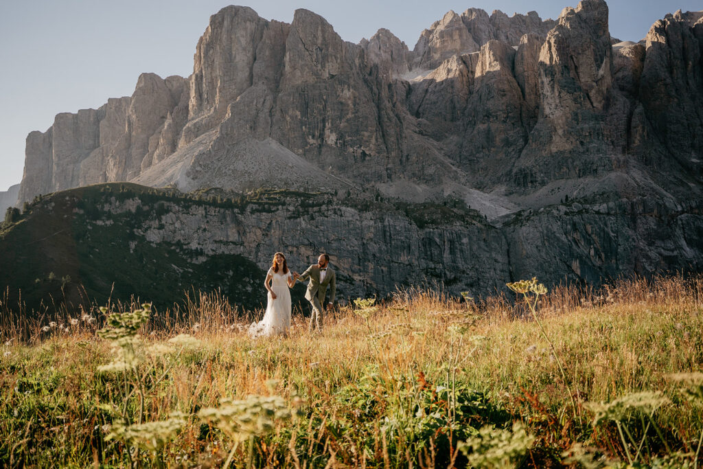 Couple walking in mountains during wedding ceremony.