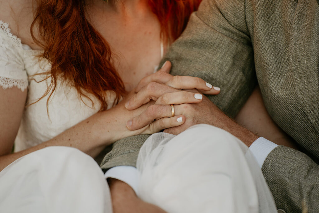 Couple holding hands, intimate moment.