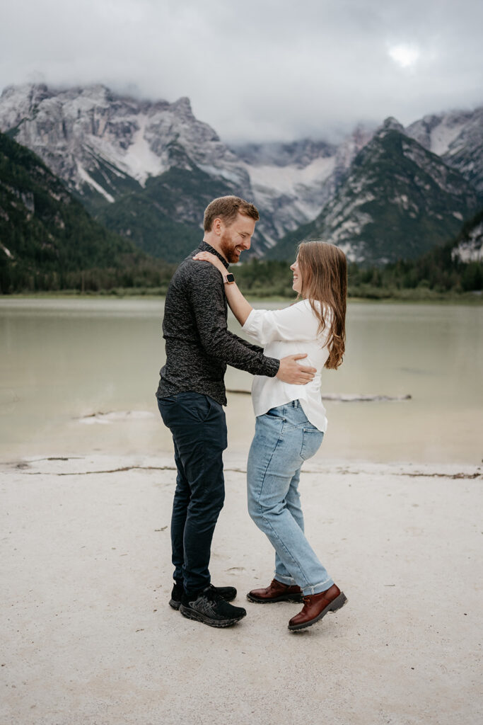 Couple embracing near mountain lake