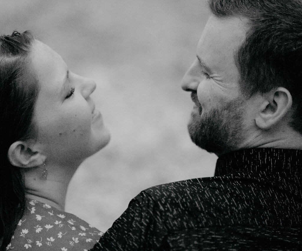 Black and white couple smiling at each other