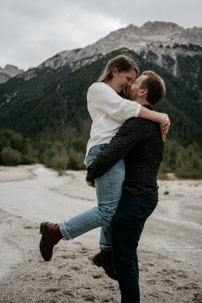 Couple embracing in picturesque mountain landscape