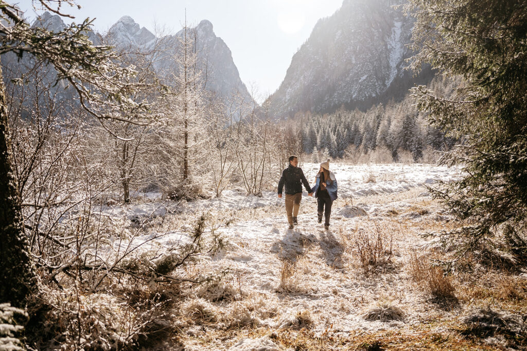 Couple walking in snowy mountain landscape