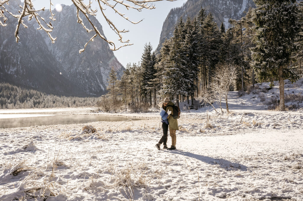 Couple embracing in snowy mountain landscape