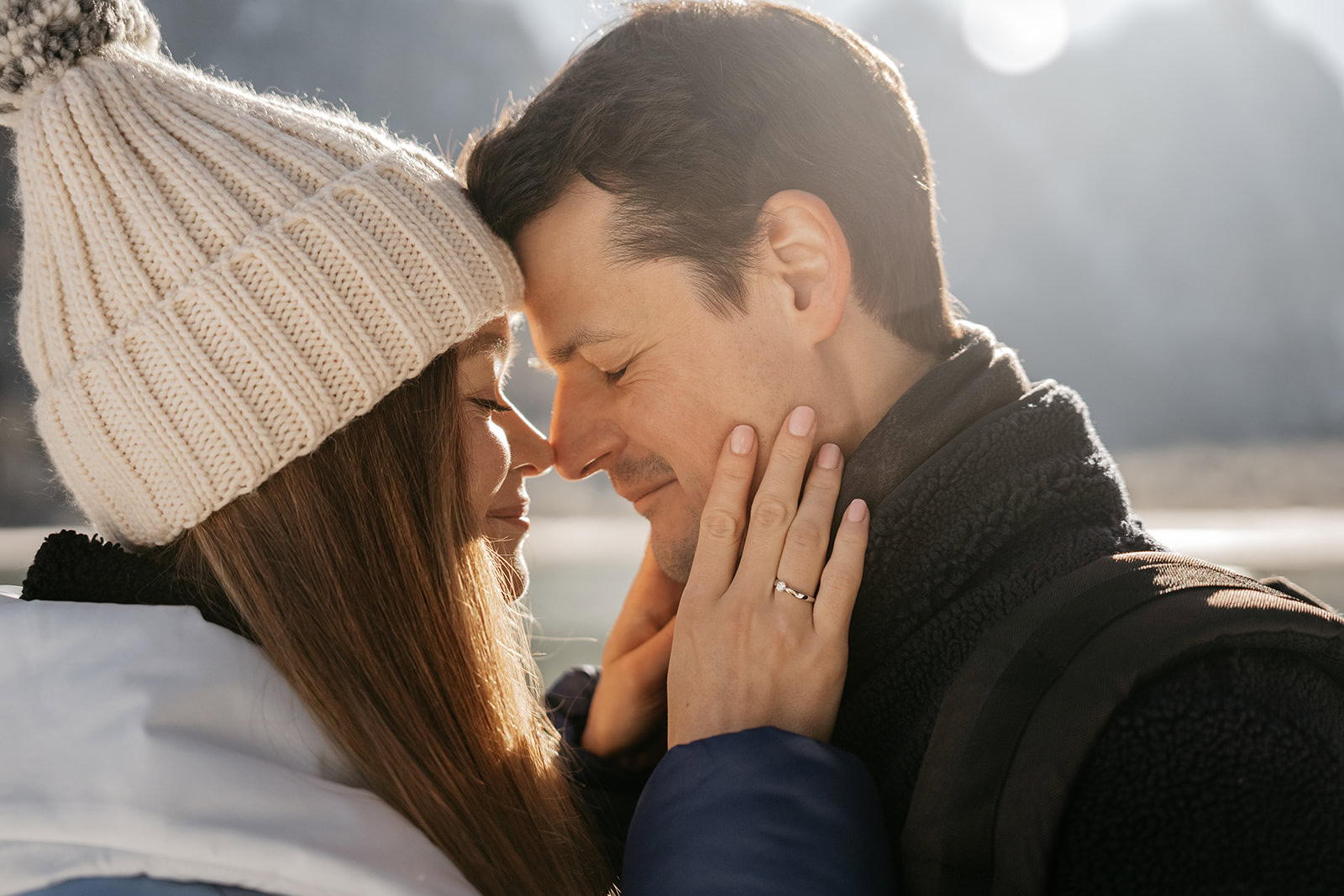 Couple in winter clothes embracing affectionately.