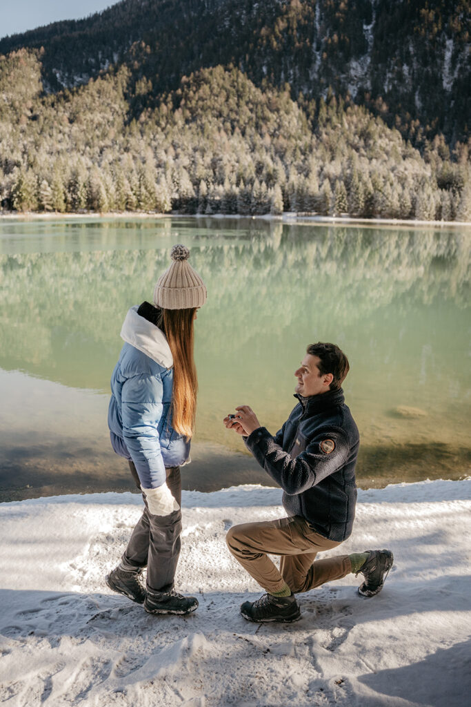 Winter proposal by snowy lake and mountains.