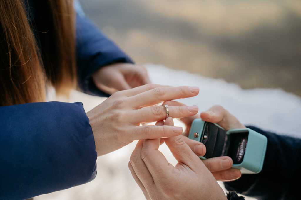 Person putting on engagement ring