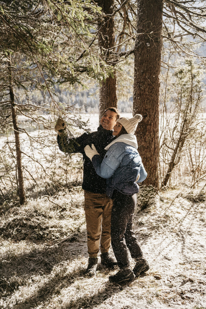 Couple enjoying snowy forest hike together.