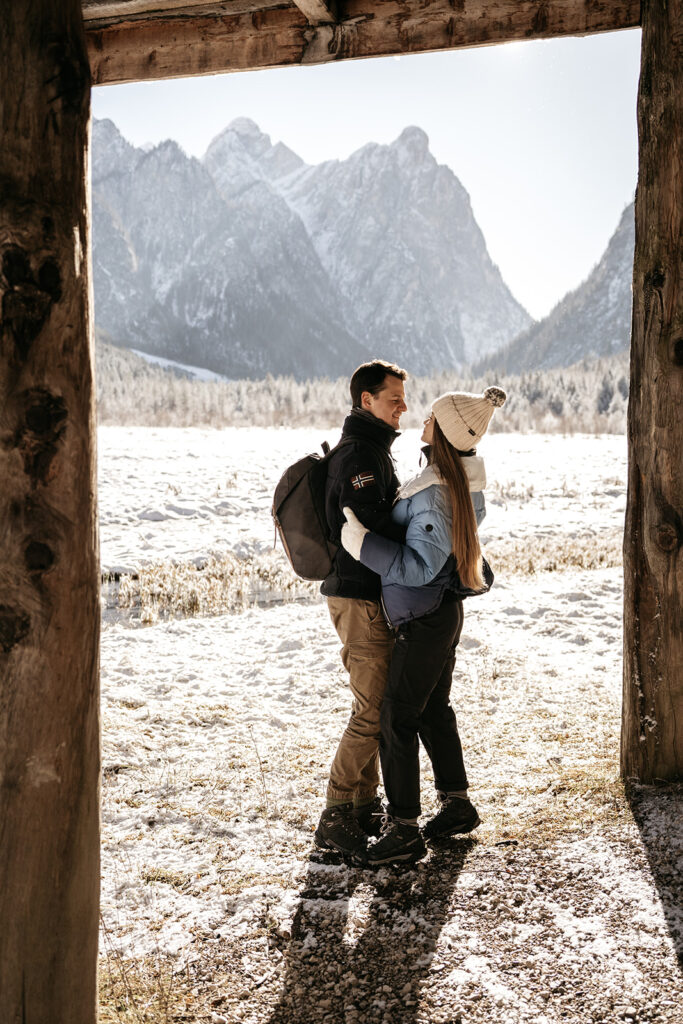 Couple hugging in snowy mountain landscape