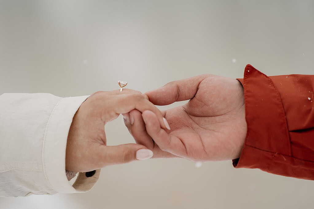 Hands holding with engagement ring