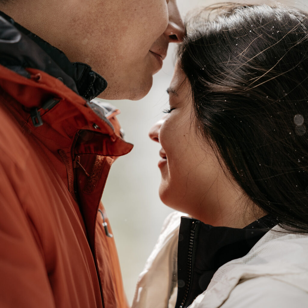 Couple sharing an intimate, tender moment outdoors.