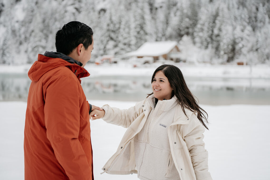 Couple smiling in snowy landscape