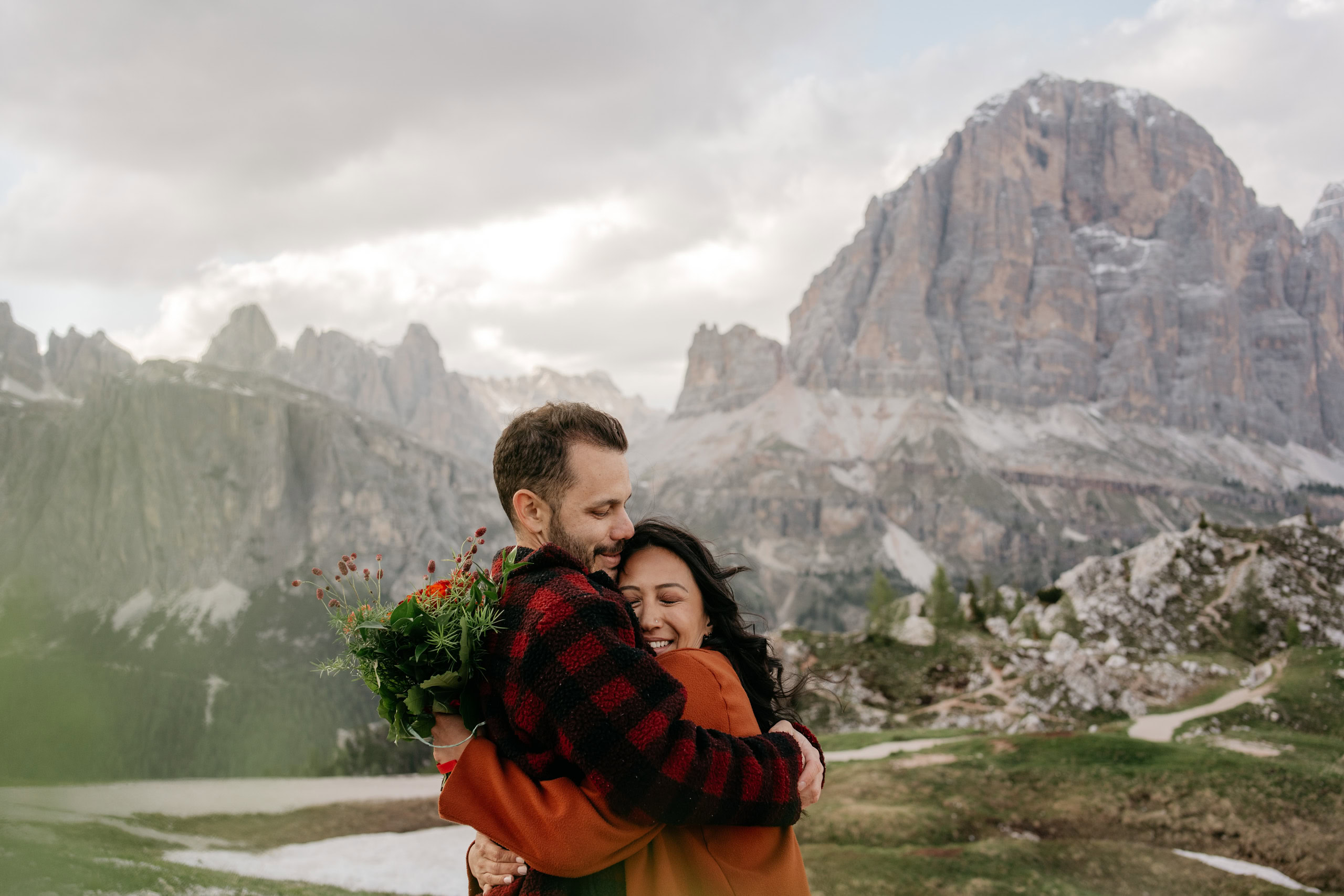 Couple embracing with mountain scenery in background