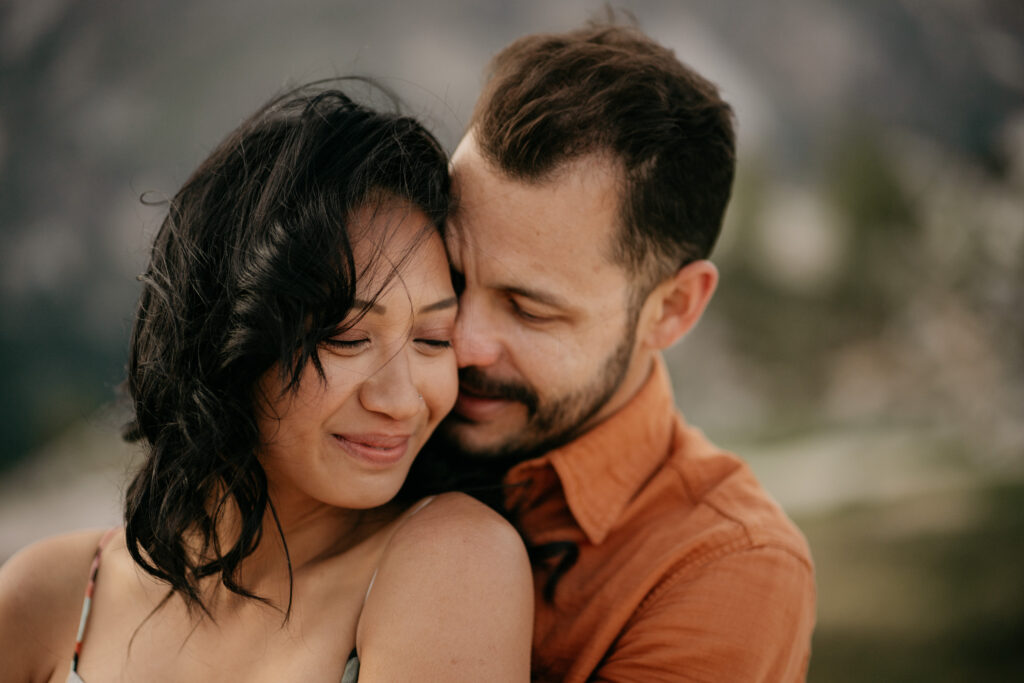 Close-up of a tender couple embracing outdoors.