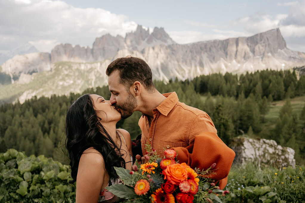 Couple kissing with mountain landscape background