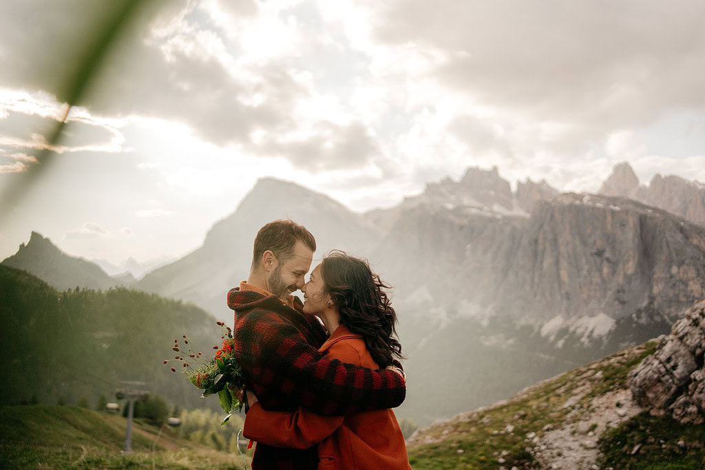 Couple embracing with mountains in the background