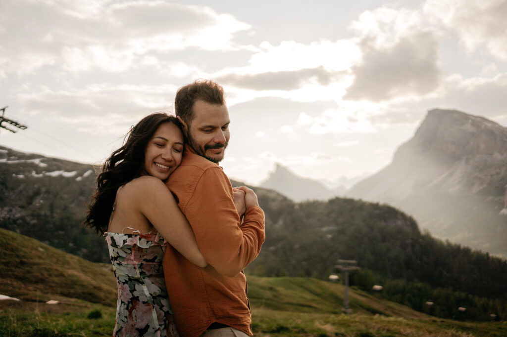 Couple embracing with mountains background.