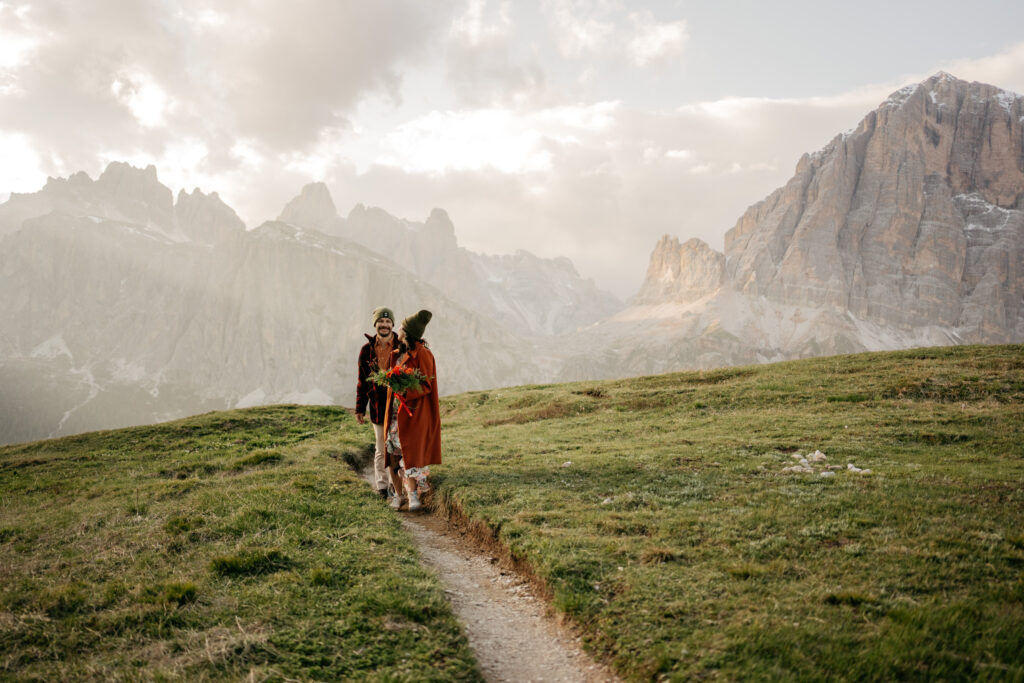 Couple hiking in picturesque mountain landscape.