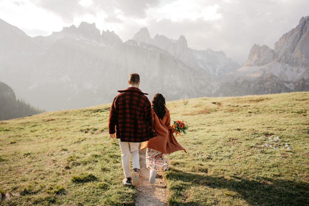 Couple walking in scenic mountain meadow