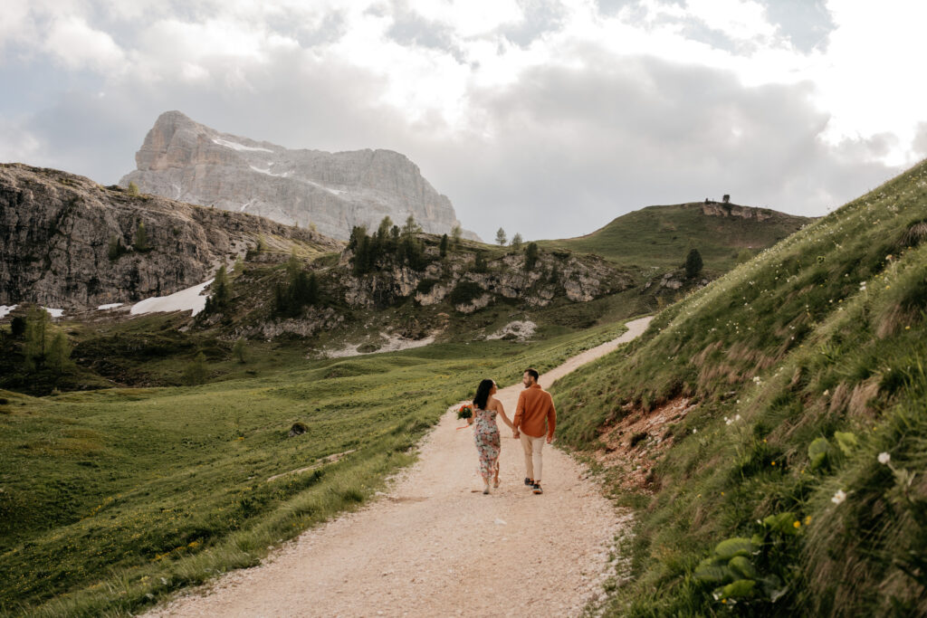 Couple walking on mountain path, scenic view