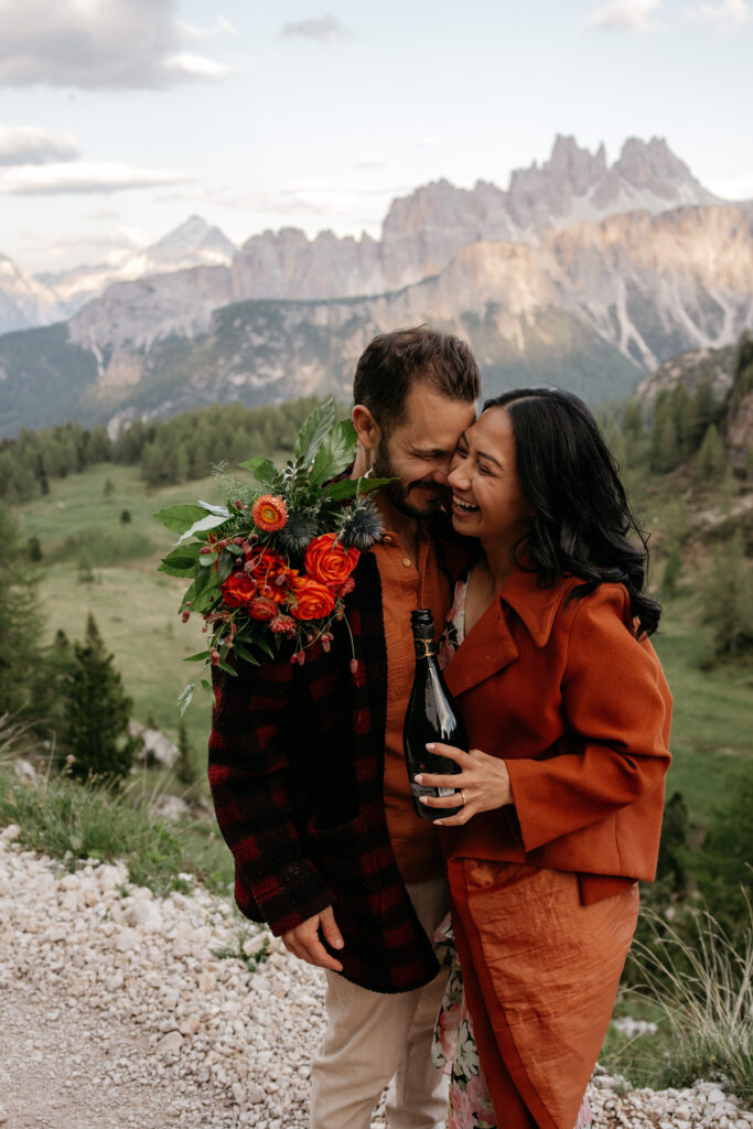 Couple embracing with flowers and mountains backdrop