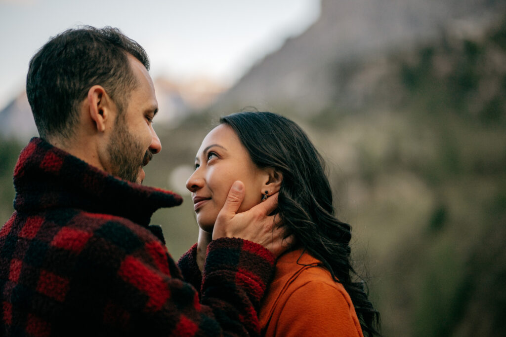 Couple gazing at each other outdoors.