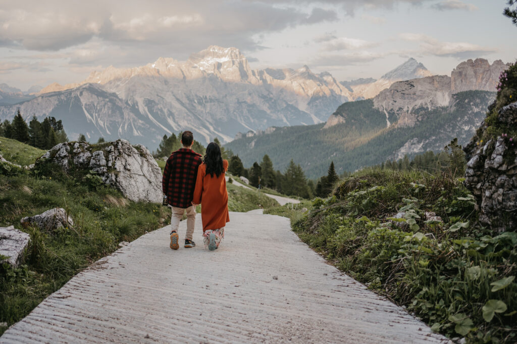 Couple walking towards picturesque mountain landscape