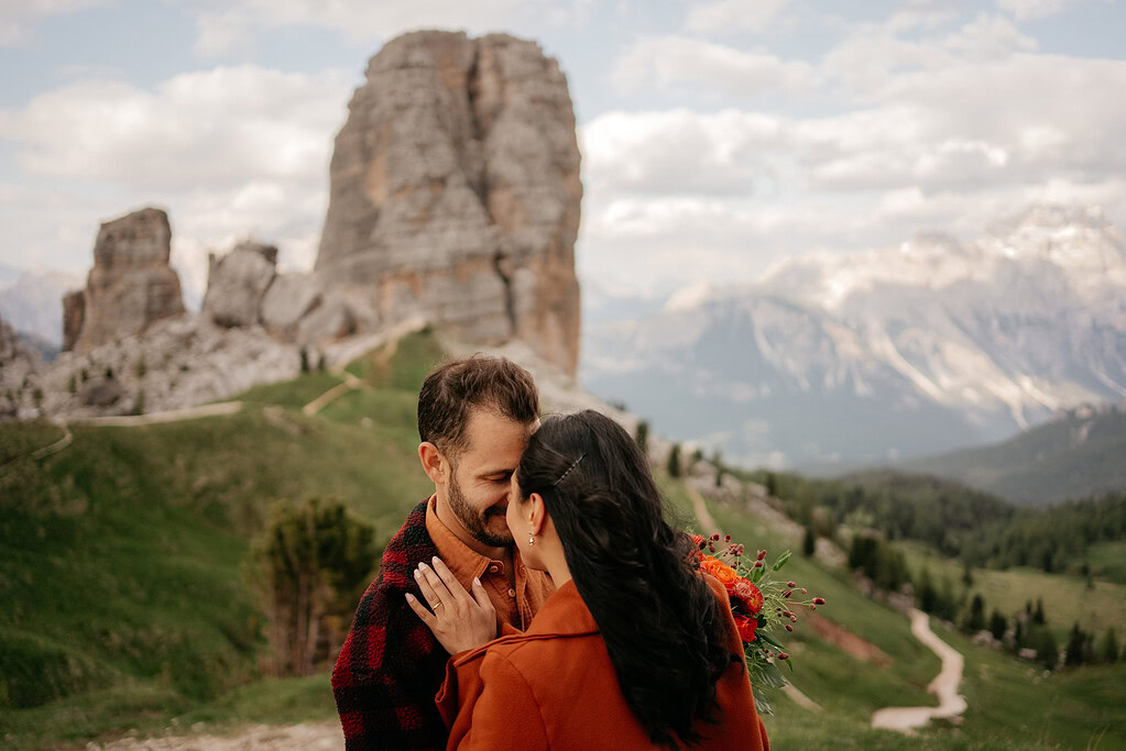 Couple embraces with scenic mountain backdrop