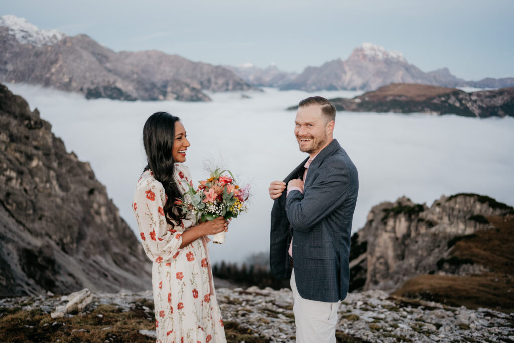 Couple enjoying mountain scenery with bouquet