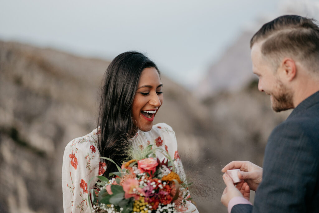 Happy couple with bouquet outdoors