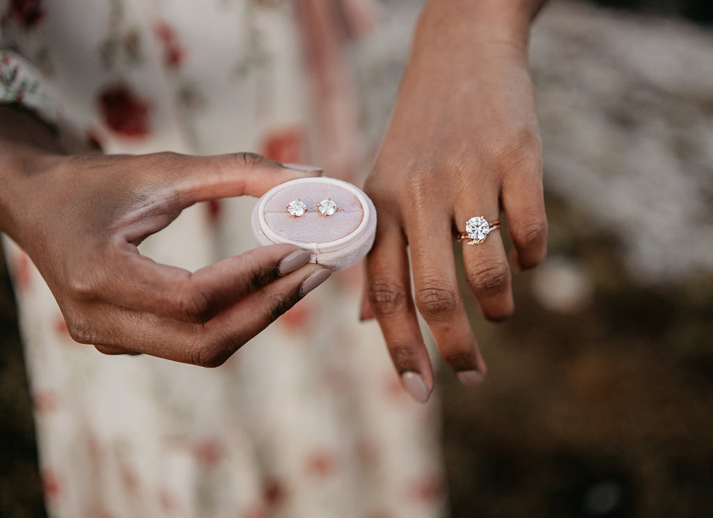 Close-up of ring and earrings in hand