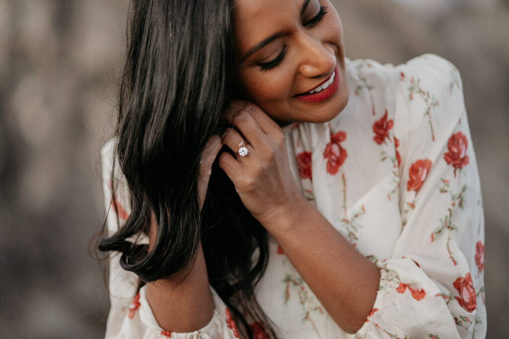 Woman smiling with floral dress and ring