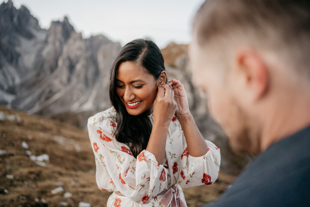 Woman smiling outdoors with mountains background