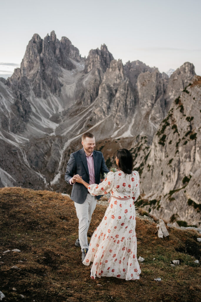 Couple dancing on scenic mountain landscape