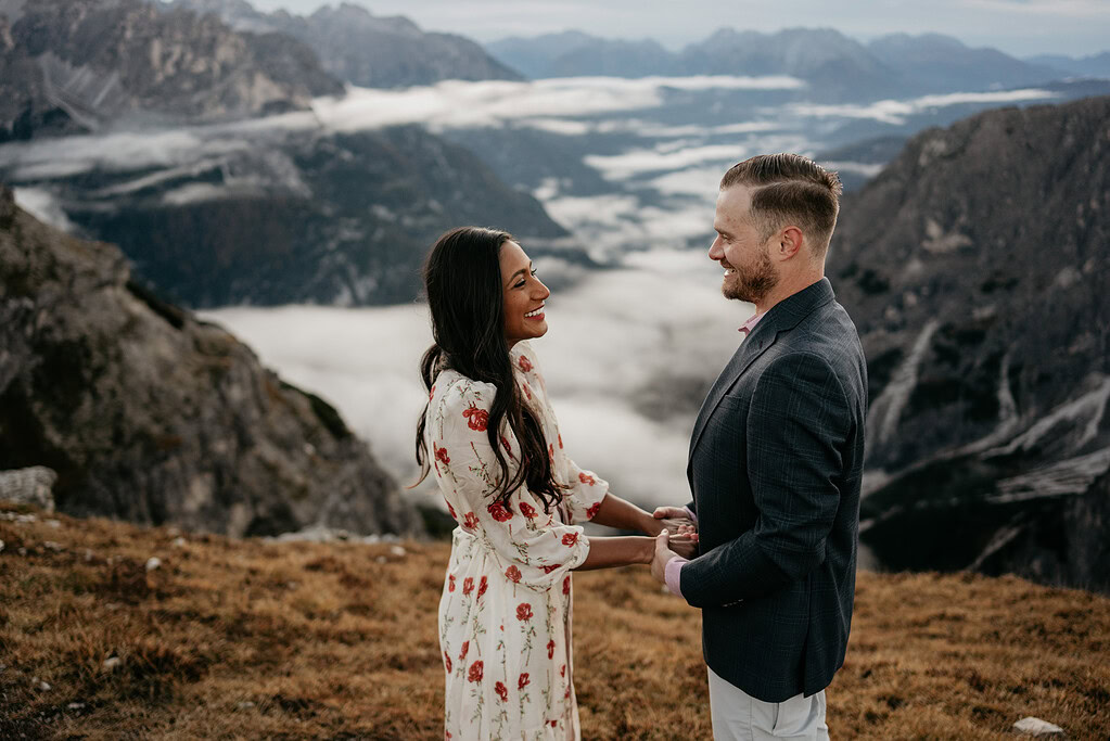 Couple smiling at mountaintop scenic view