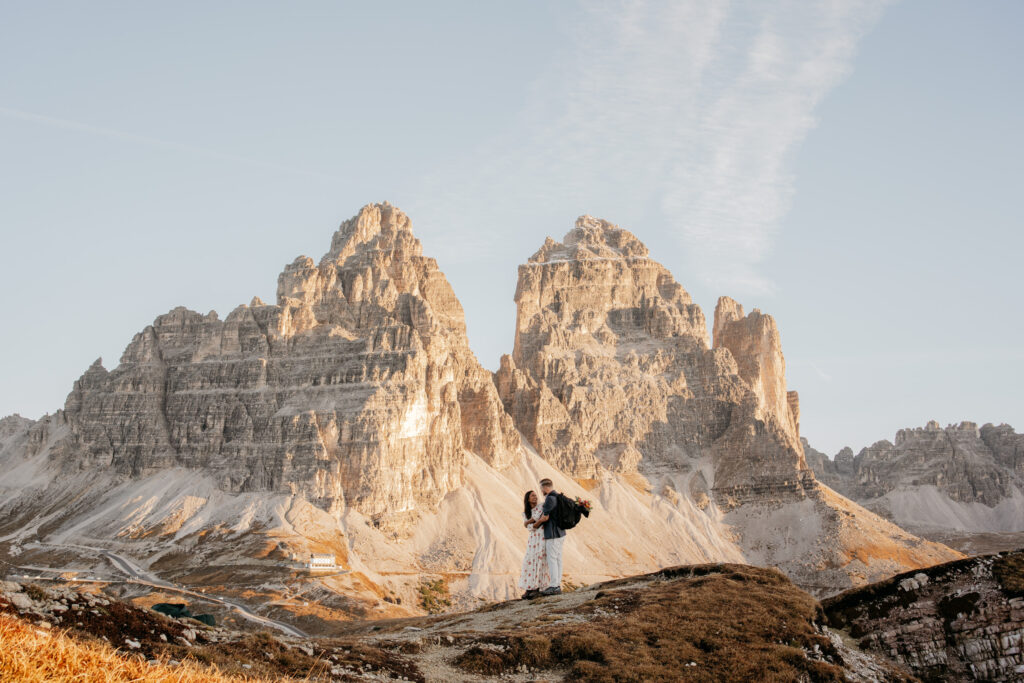 Couple standing in front of mountainous landscape