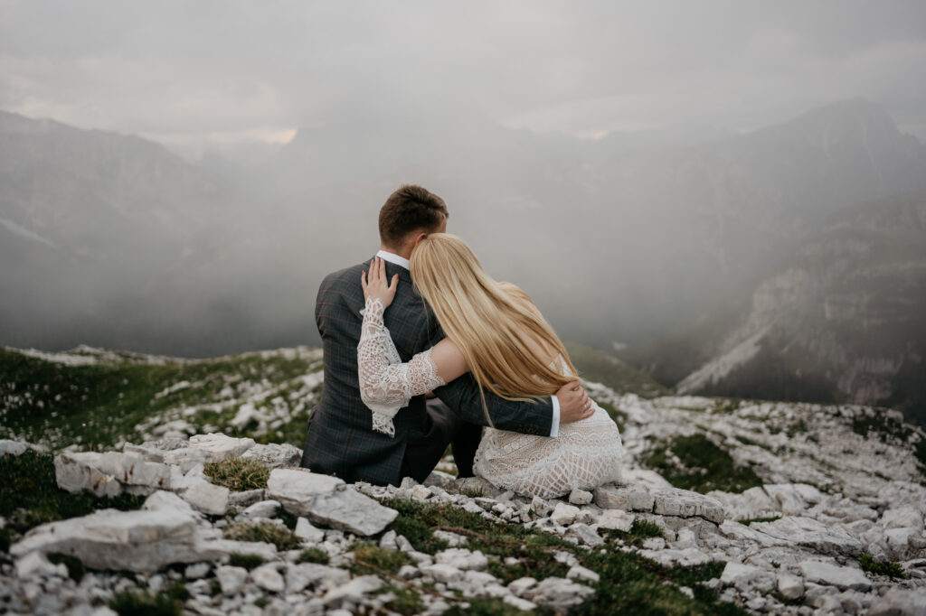 Couple embracing on foggy mountain landscape