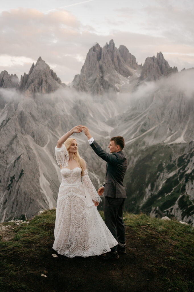 Couple dancing in stunning mountain scenery