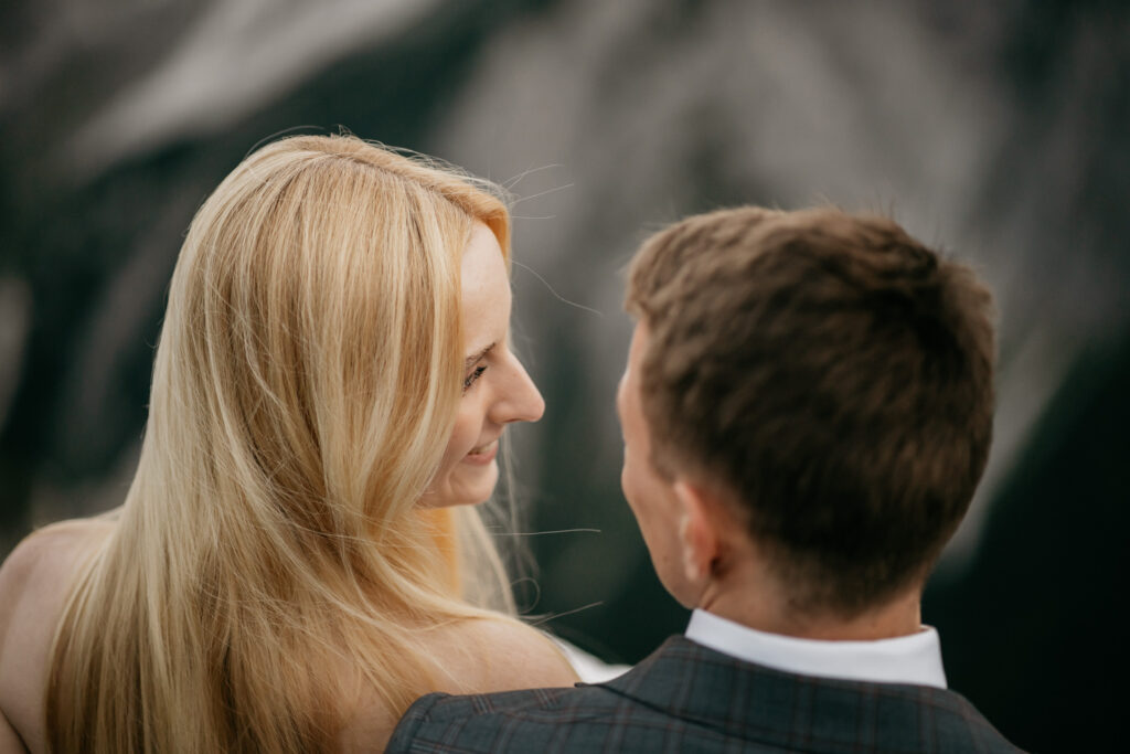 Couple smiling at each other outdoors.