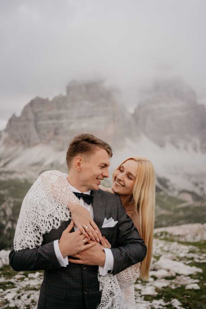 Smiling couple embracing with mountain backdrop