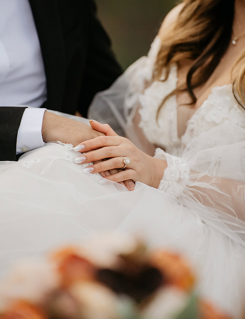 Bride and groom holding hands at wedding