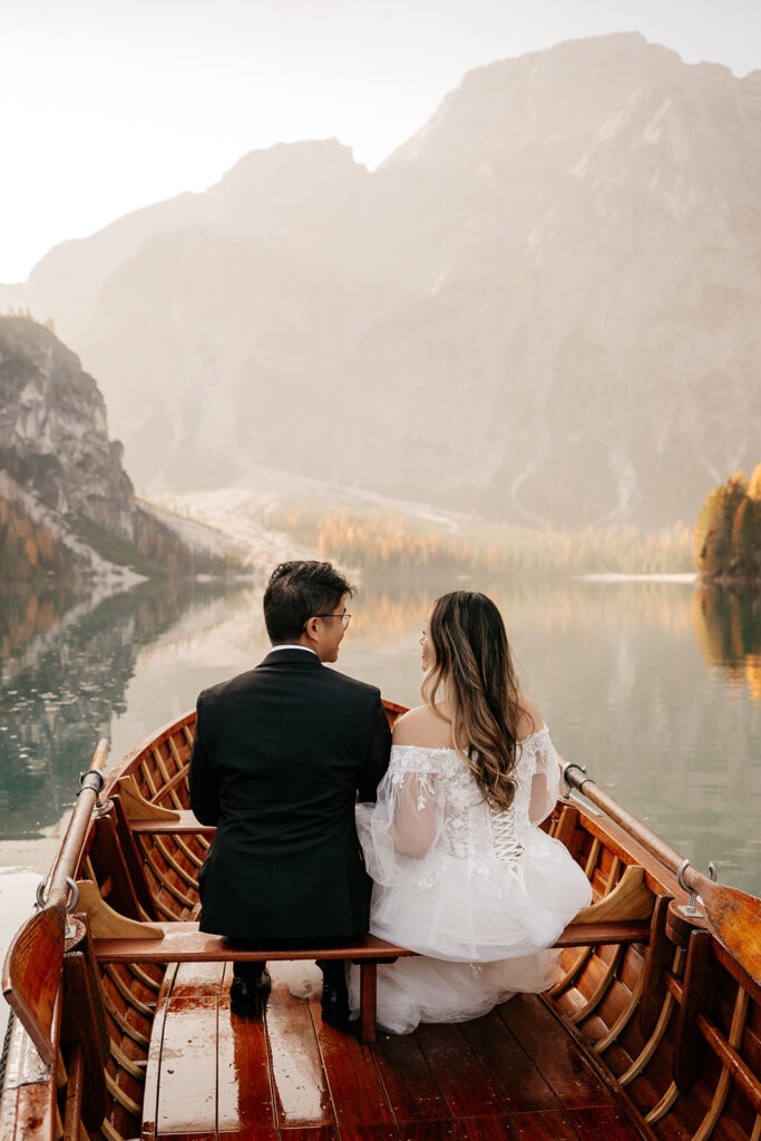 Couple in boat, mountain landscape background.