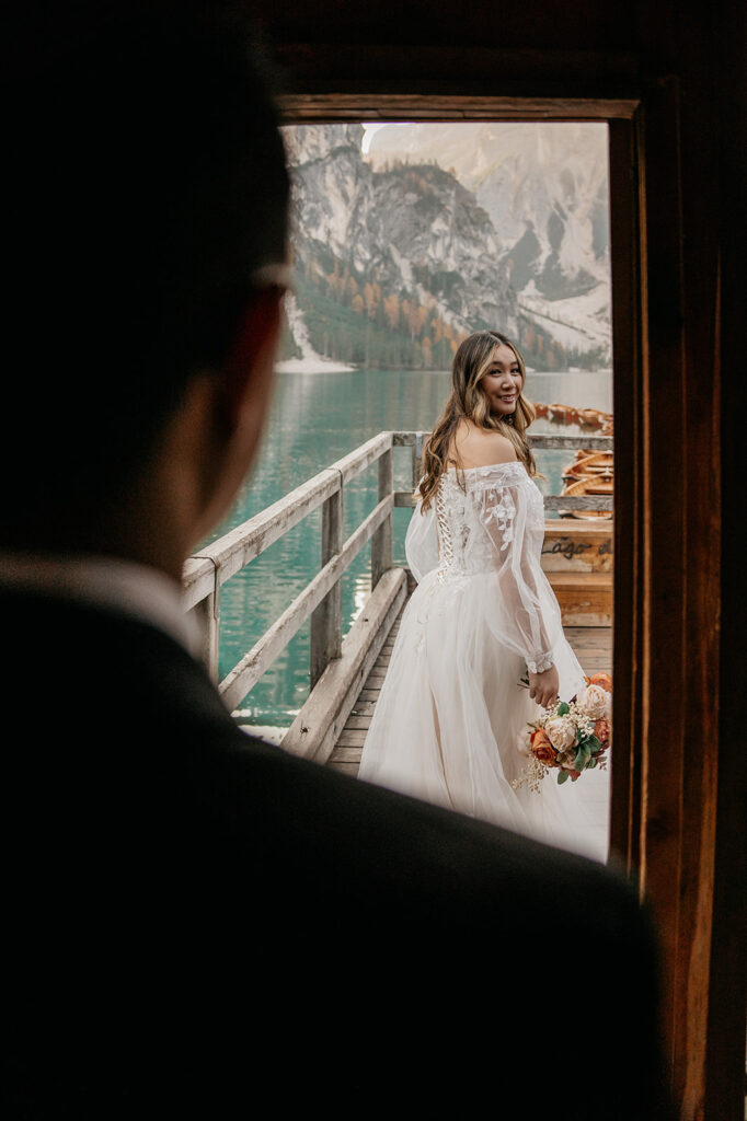 Bride on dock by mountain lake