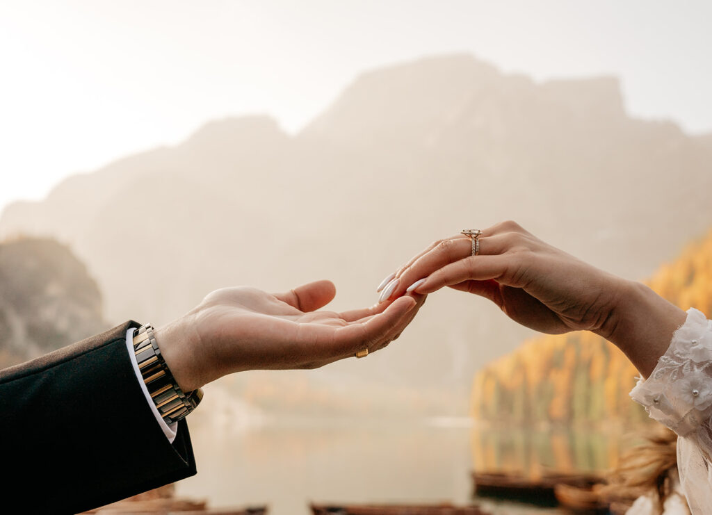 Hands reaching, romantic mountain view.