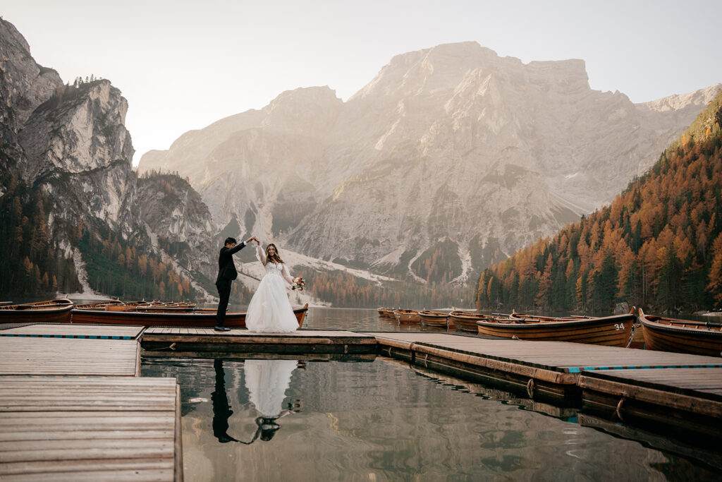 Bride and groom dancing on mountain dock.