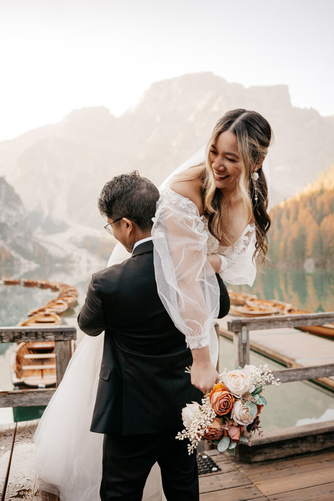 Bride and groom by peaceful mountain lake