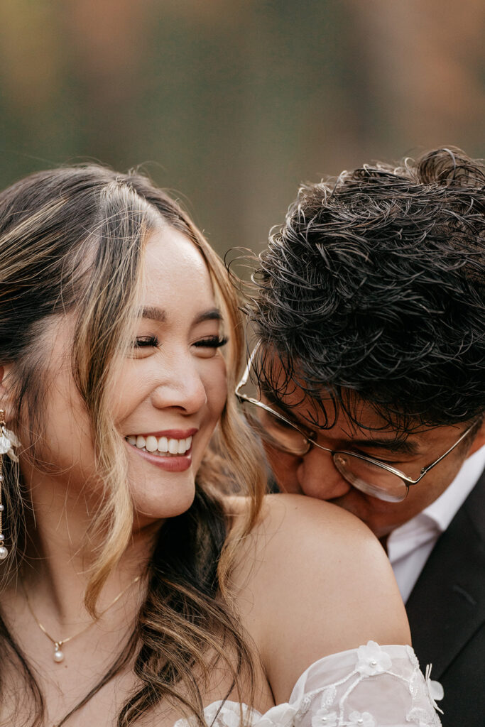 Couple smiling and embracing joyfully outdoors