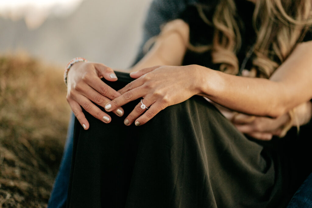 Woman's hands with engagement ring, close-up view.