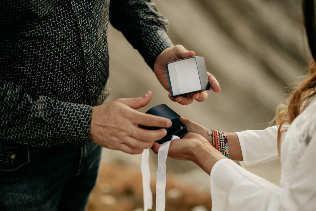 Couple exchanging a jewelry gift box.