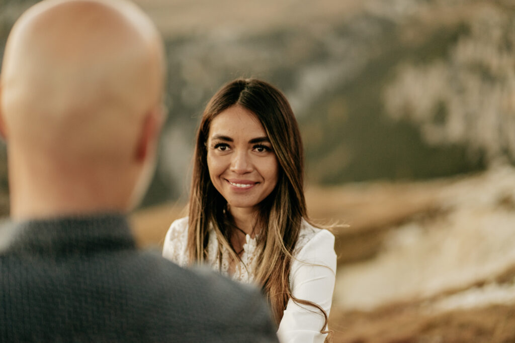 Woman smiling outdoors with blurred background