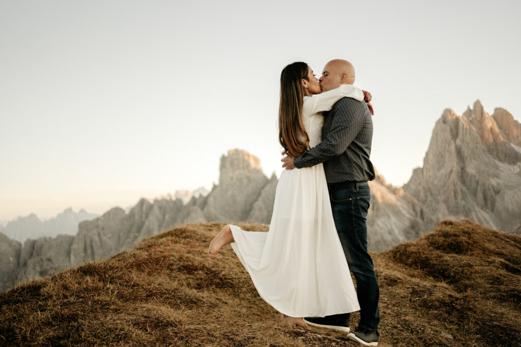 Couple kissing on mountain, romantic scenery